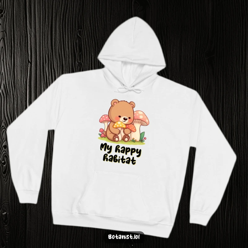 Funny bear cub mushroom hoodie, depicting a contented cub gently tending large, colorful mushrooms, perfect for warmth and humor.