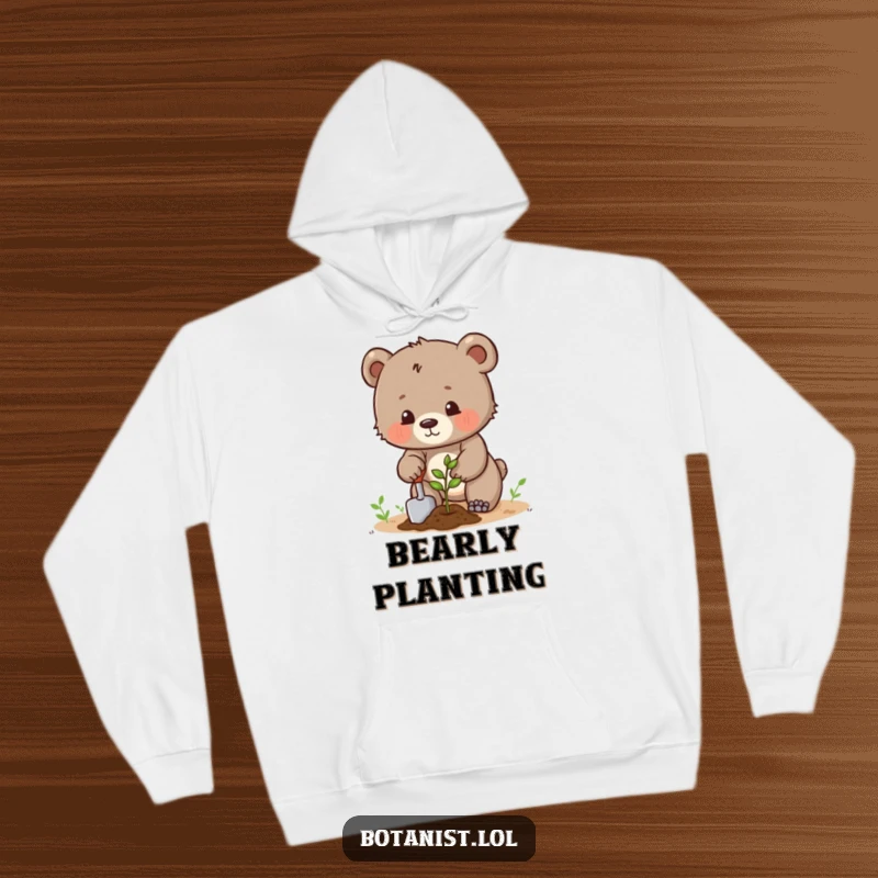 Funny determined bear cub planting a seed with a trowel, a cozy and humorous gardening hoodie. Ideal gift.