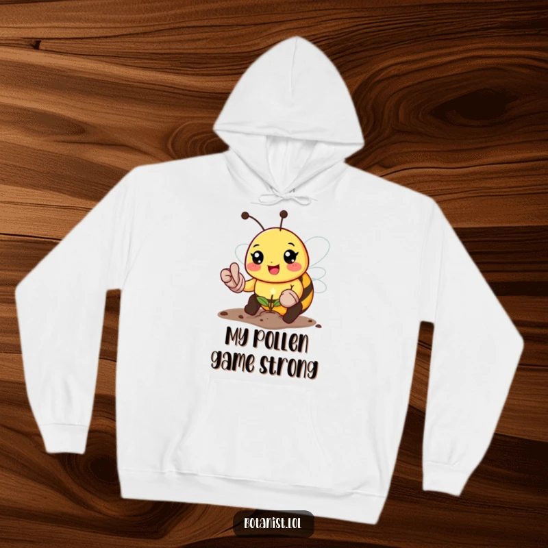 Funny bee gardener hoodie, depicting a cheerful bee in gardening gloves planting a tiny sparkling seed, promoting warmth and humor.