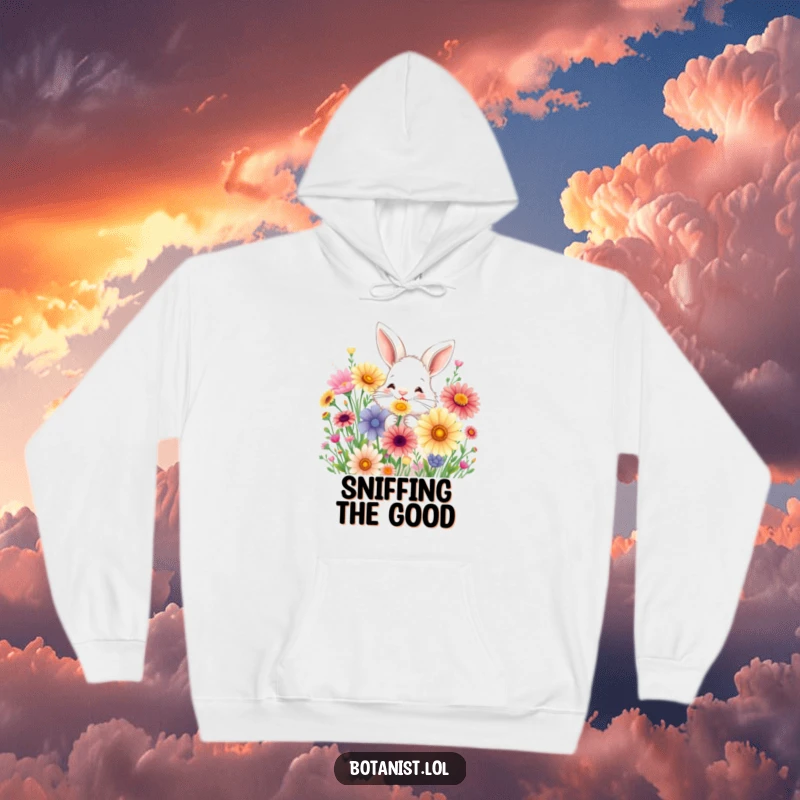Funny hoodie with a fluffy bunny joyfully sniffing a bouquet of oversized, colorful wildflowers.