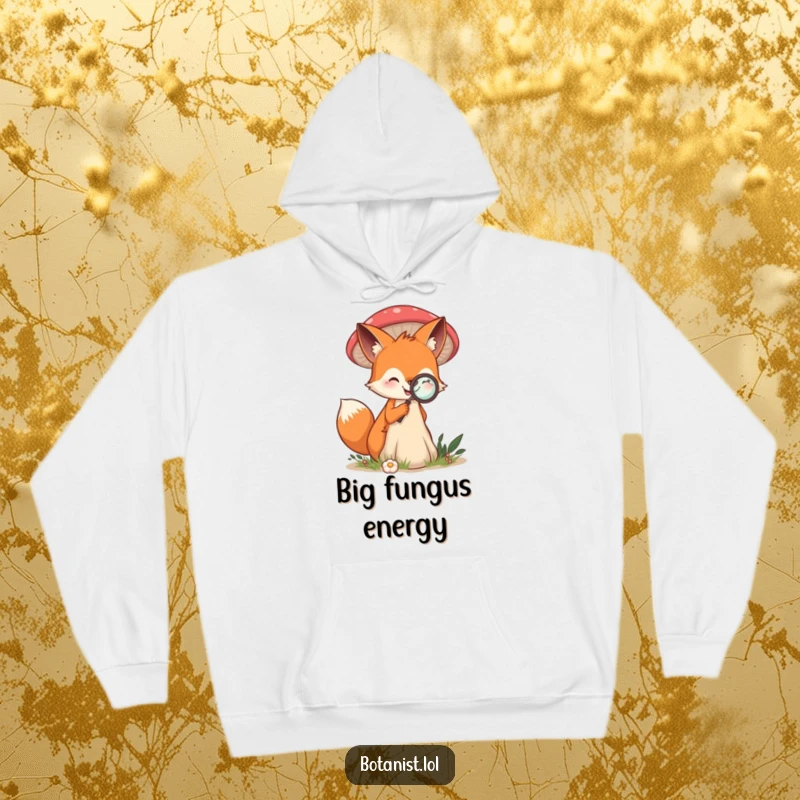 Funny hoodie depicting a smiling fox examining a giant mushroom with a magnifying glass, embodying curiosity.