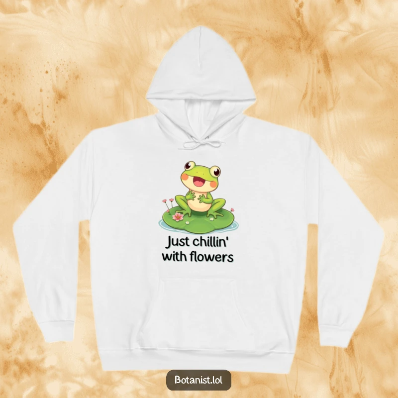 Funny hoodie featuring a cheerful frog on a big lily pad, looking at tiny blooms, a sweet and humorous scene.