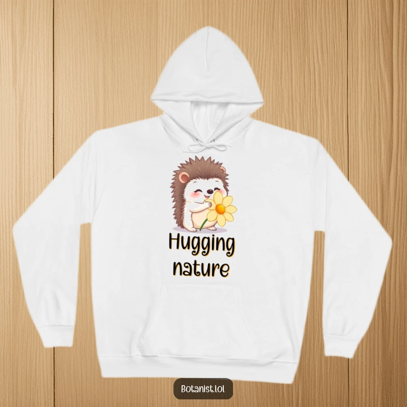 Funny hoodie featuring a happy hedgehog gently hugging a flower, soft and heartwarming.