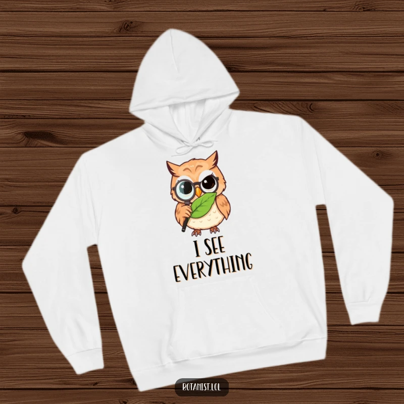 Funny owl detective hoodie, a wise owl with a magnifying glass meticulously observing a detailed leaf, offering warmth and humor.