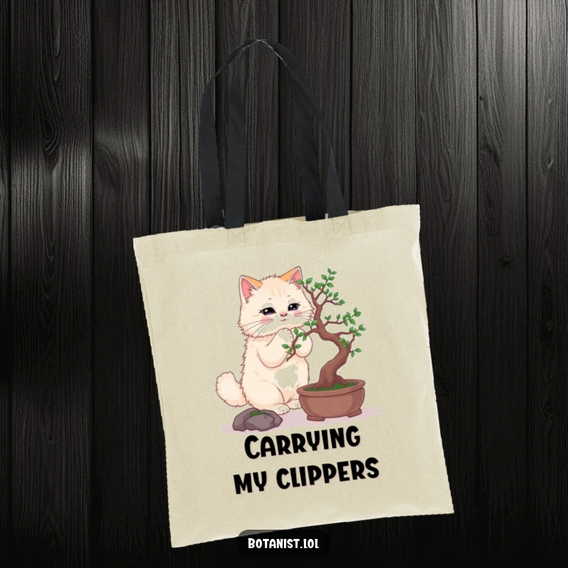 Funny tote bag showing a fluffy cat delicately shaping a bonsai tree, embodying meticulous care.